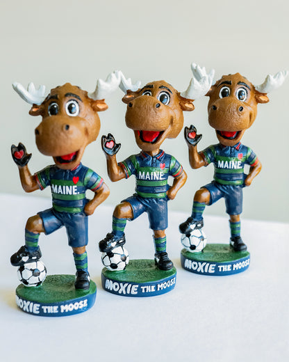 Three bobblehead figures of a moose mascot in Maine sports attire on a white background.